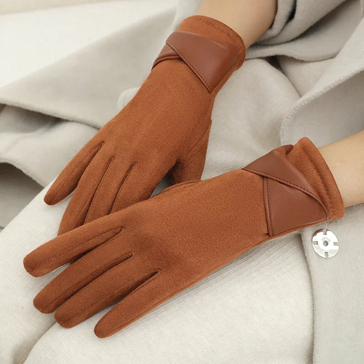 brown wool gloves with leather trim worn on hands over beige coat fabric