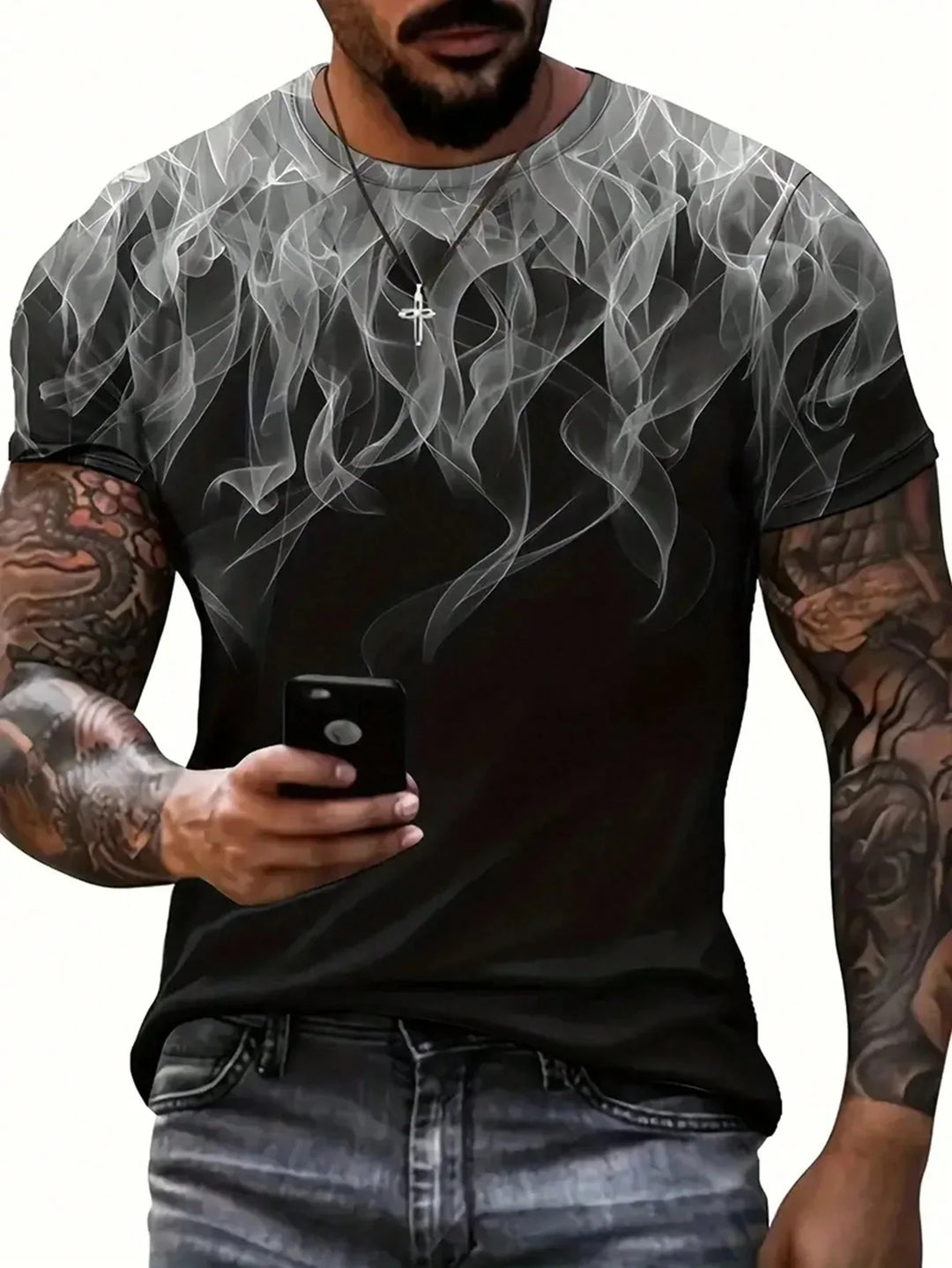 Tattooed man wearing black t-shirt with white smoke pattern holding smartphone