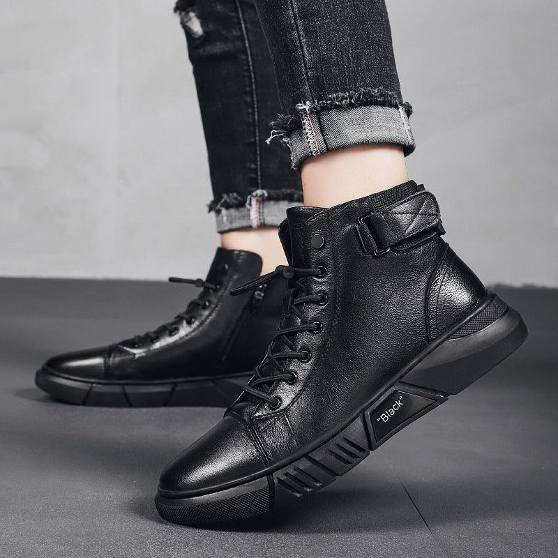 Black leather high-top sneakers with laces and buckle worn with rolled-up distressed black jeans