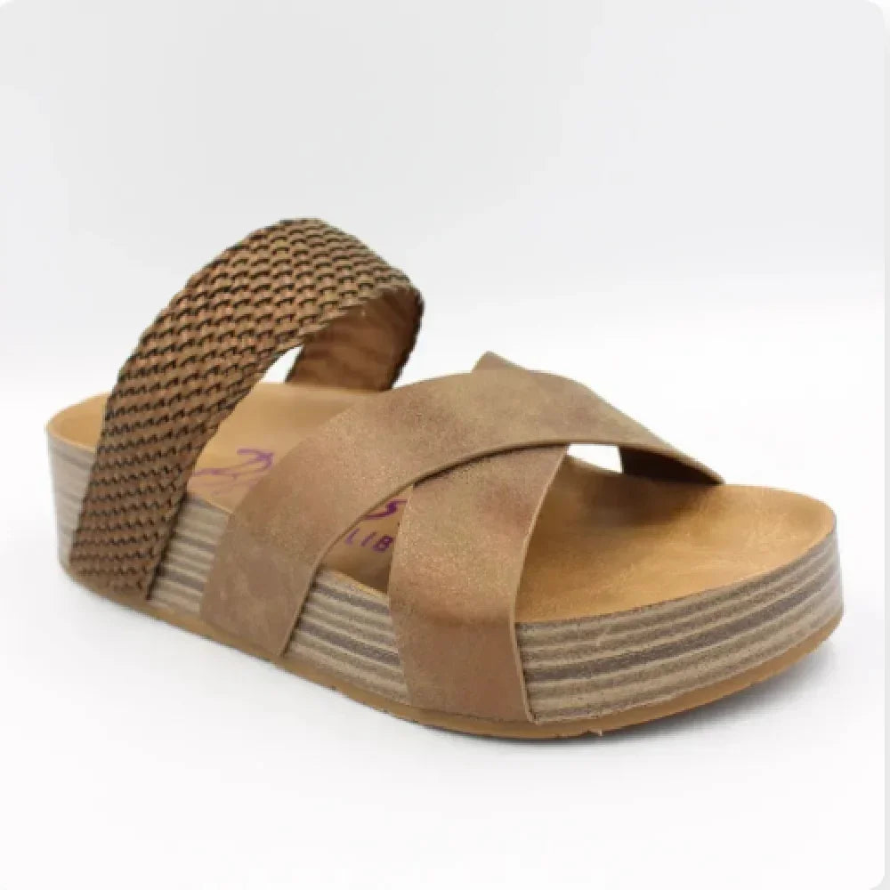 Brown women's sandal with crisscross front straps and woven back strap on platform sole
