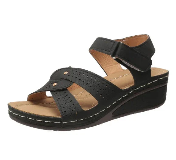 Black women's wedge sandal with perforated straps and adjustable ankle Velcro closure