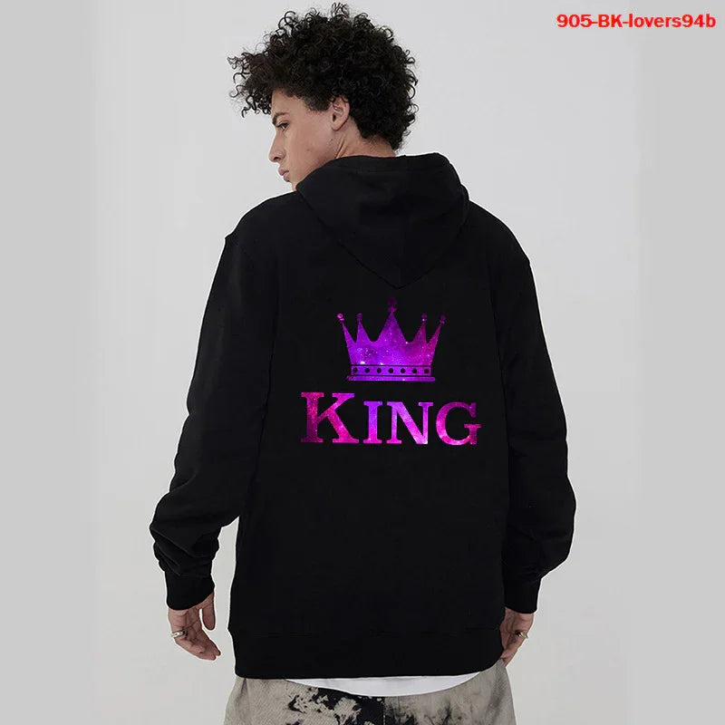 Man wearing black hoodie with purple crown and King text on back against gray background