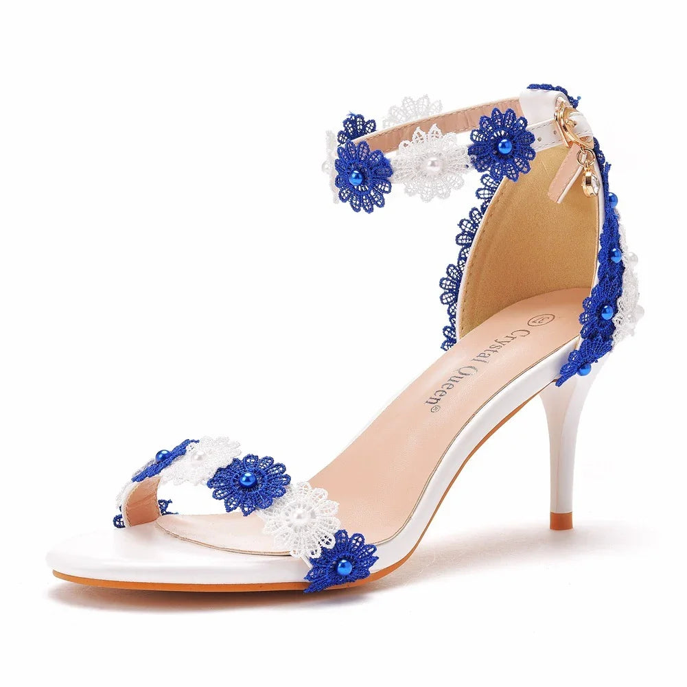 White high-heeled sandal with blue and white lace flowers and bead embellishments
