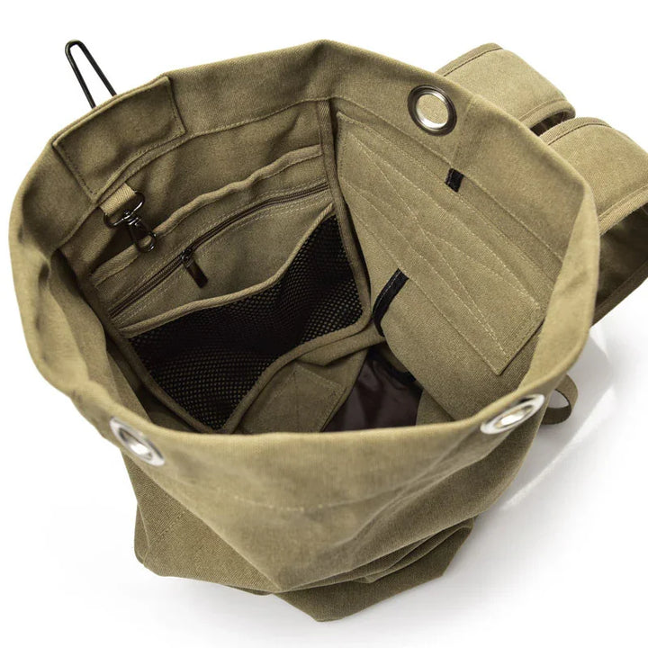 Top view of open olive green canvas backpack showing interior zipper pocket and mesh compartment