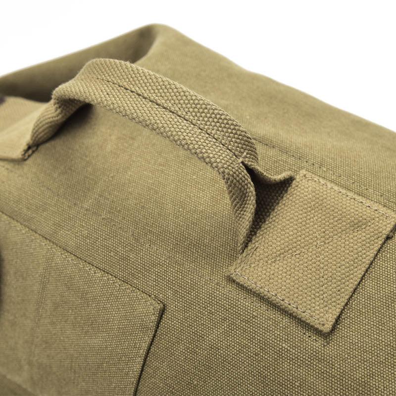 Close-up of durable khaki canvas fabric bag with reinforced handle and stitching detail