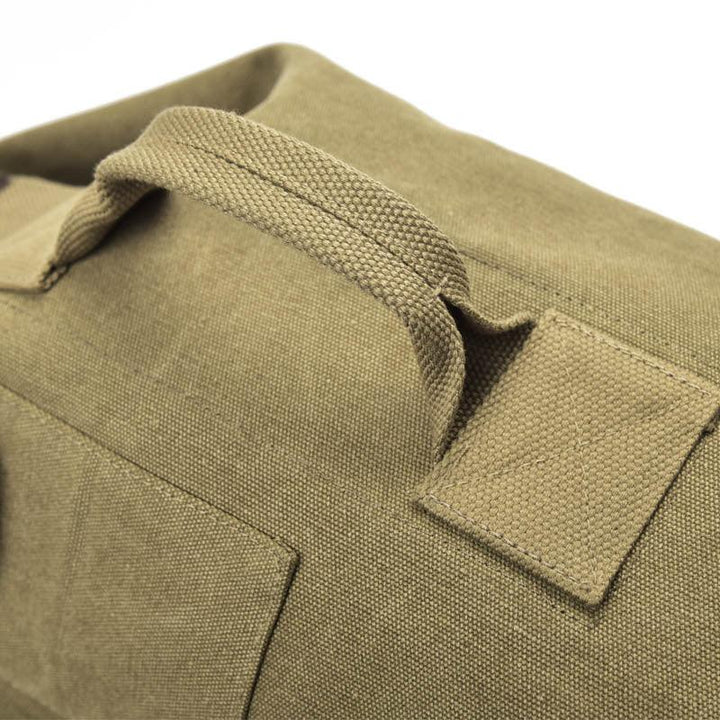 Close-up of durable khaki canvas fabric bag with reinforced handle and stitching detail