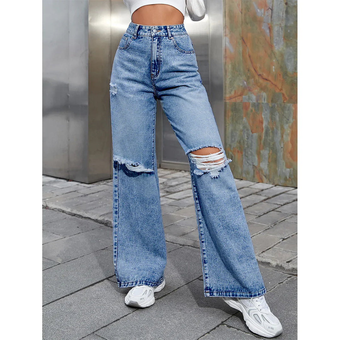 High waist light blue ripped wide-leg jeans with distressed details worn with white sneakers
