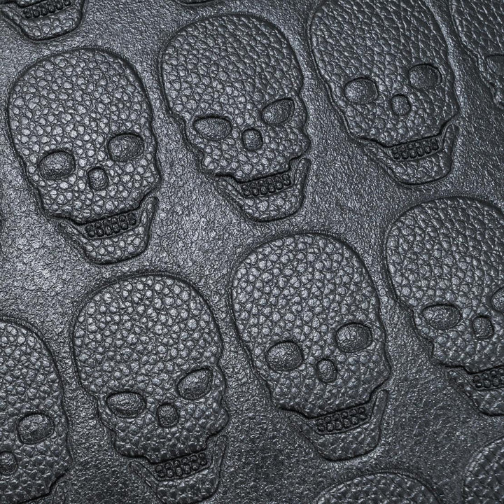 Close-up of textured black skull pattern embossed on a leather surface