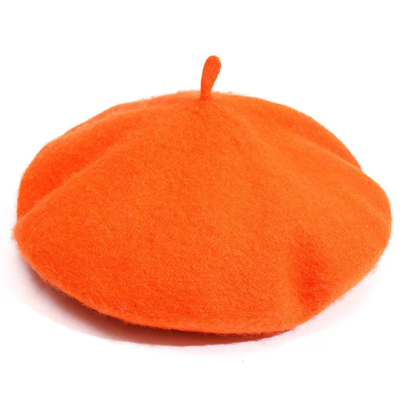 Bright orange wool beret hat with top stem detail on white background