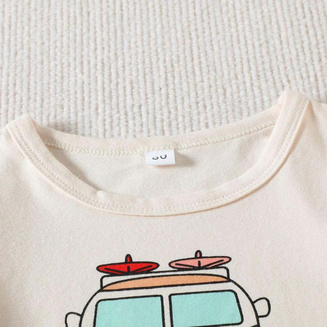 Close-up of beige cotton t-shirt neckline with car and surfboard graphic print on textured white surface