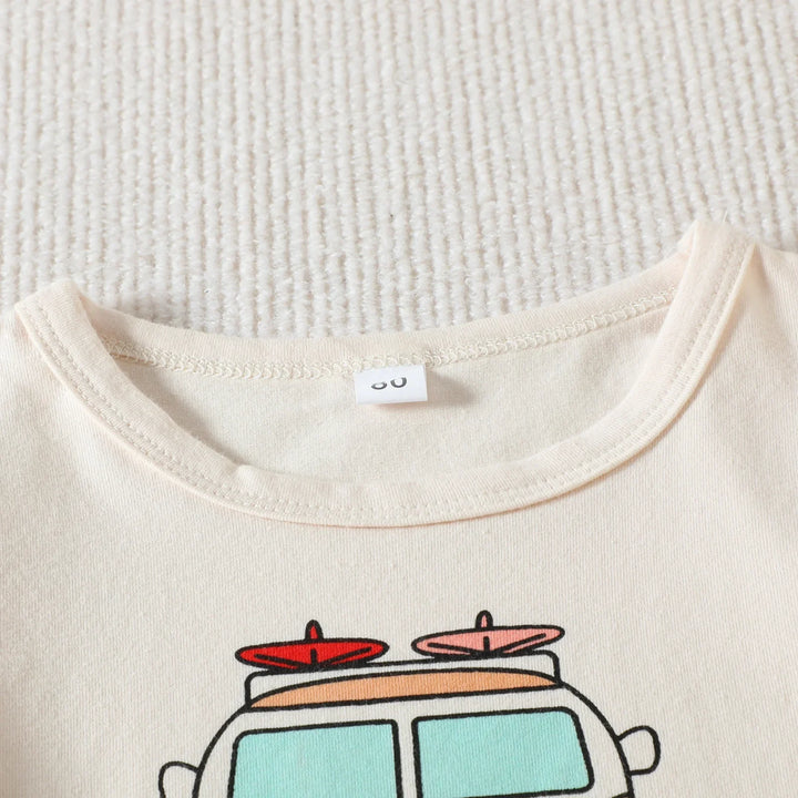 Close-up of beige cotton t-shirt neckline with car and surfboard graphic print on textured white surface