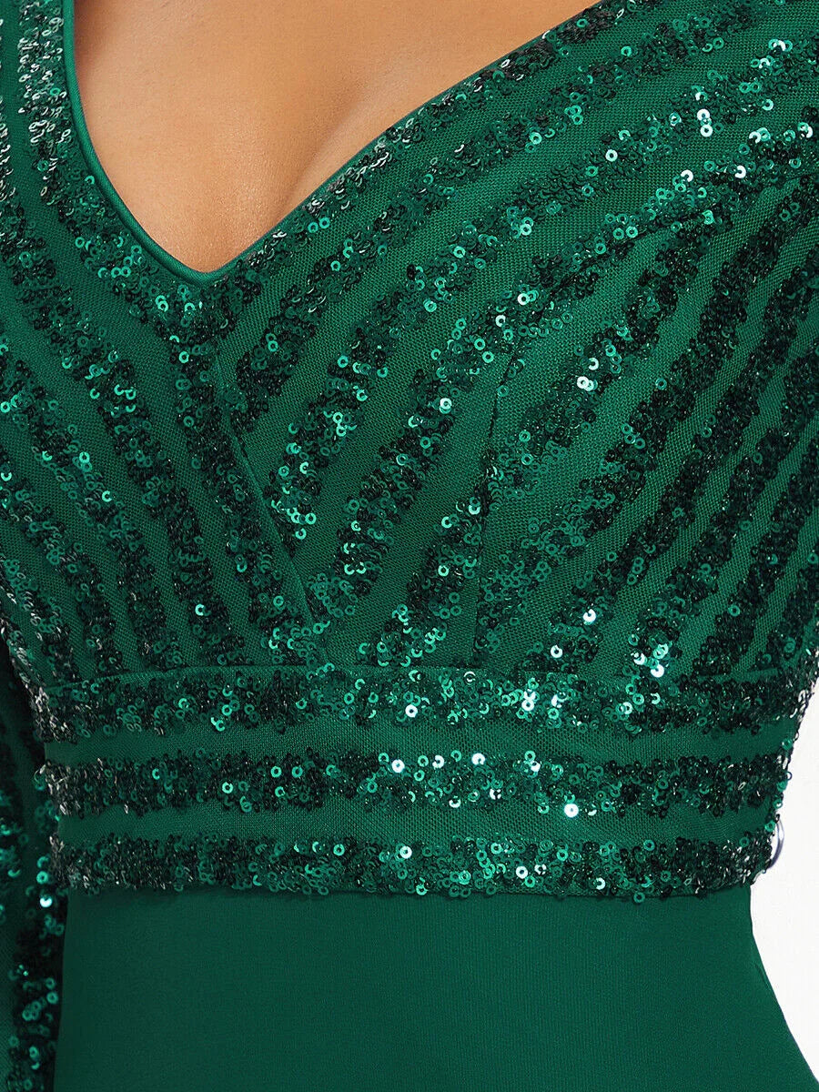 Close-up of green V-neck dress with glittering sequin stripes and fitted waist