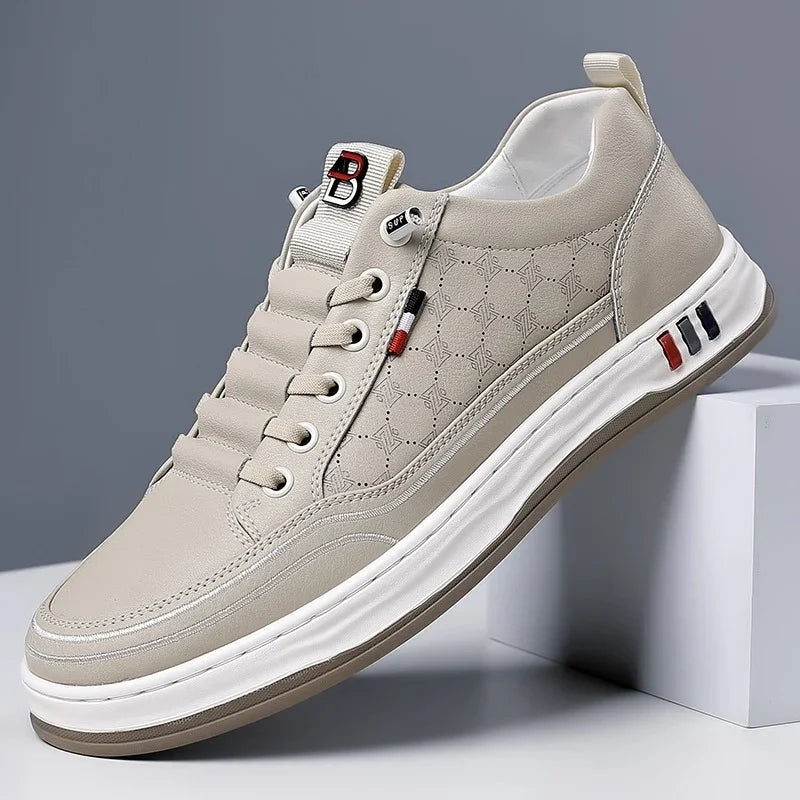 Beige casual sneaker with white sole, textured side pattern, and red, black striped accents