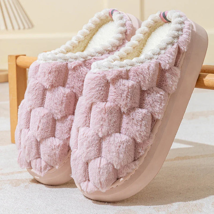 soft pink plush indoor slippers with cushioned soles and fluffy white lining