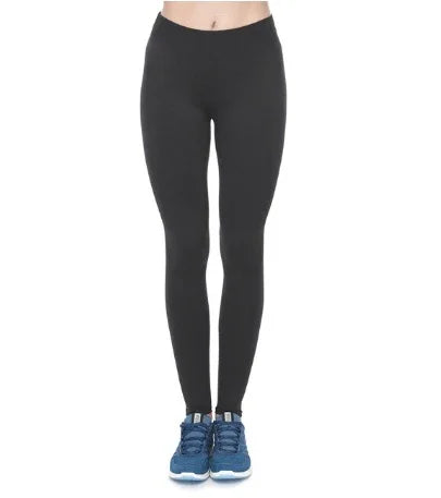 Front view of woman wearing black leggings and blue athletic shoes on white background