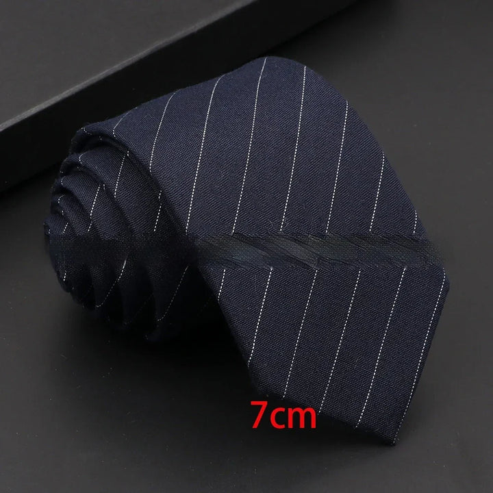 Rolled navy blue pinstripe necktie measuring 7cm wide on black surface