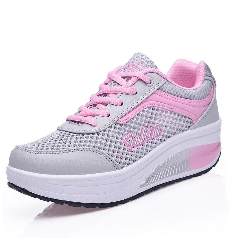 Light gray and pink breathable mesh women's sneaker with thick white sole and pink laces