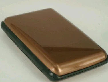 Compact metallic bronze card holder case on white background