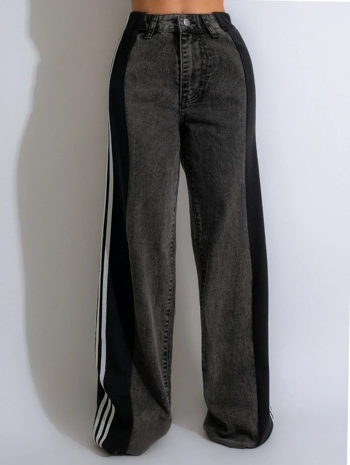 High-waisted black and dark gray wide-leg jeans with stripes down the sides
