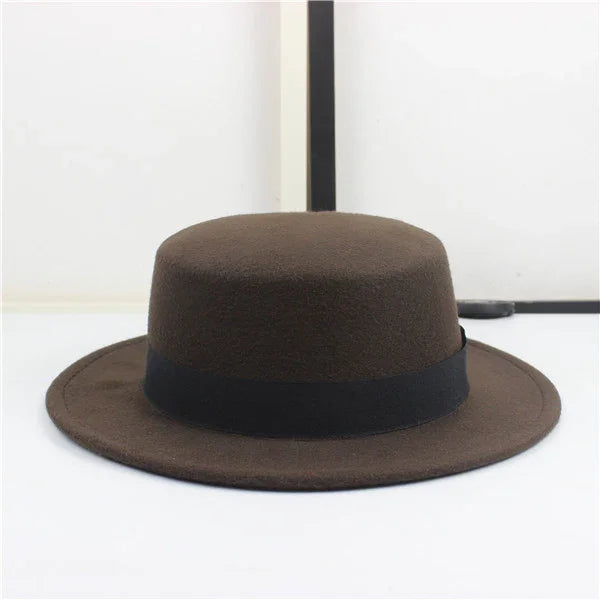 Brown felt fedora hat with black band on white background