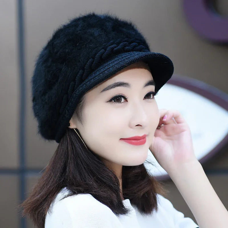 Young woman wearing stylish black fuzzy winter hat with braided detail and white top