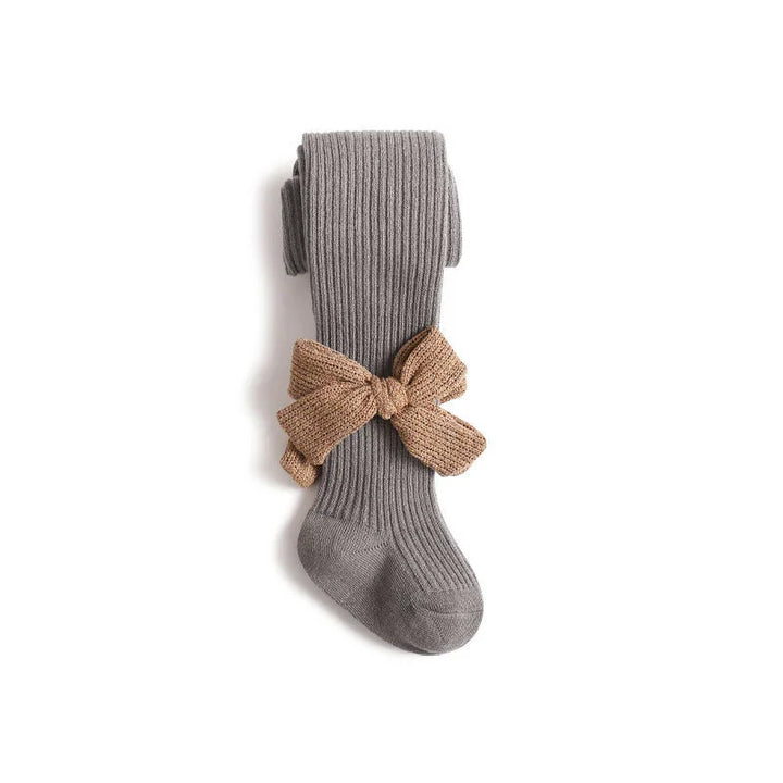 Gray ribbed knit tights with a large brown knitted bow on a white background