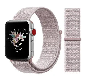 Silver smartwatch with pink nylon loop band and floral digital watch face showing 11:09