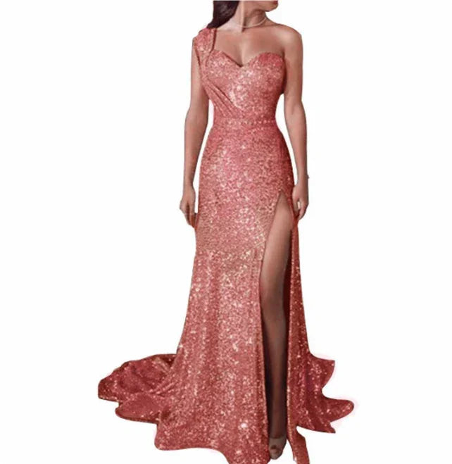 woman wearing a rose gold sequined one-shoulder evening gown with thigh-high slit and train