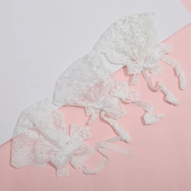White lace bridal gloves with bow accents on pink and white background