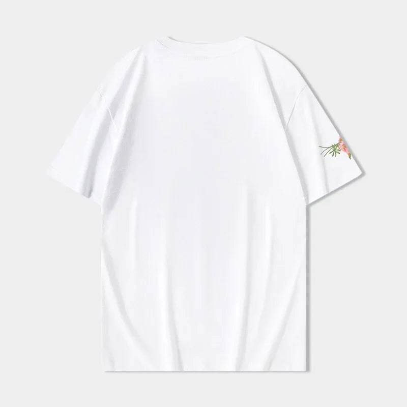 Plain white short sleeve t-shirt with small floral print on right sleeve, displayed on light background