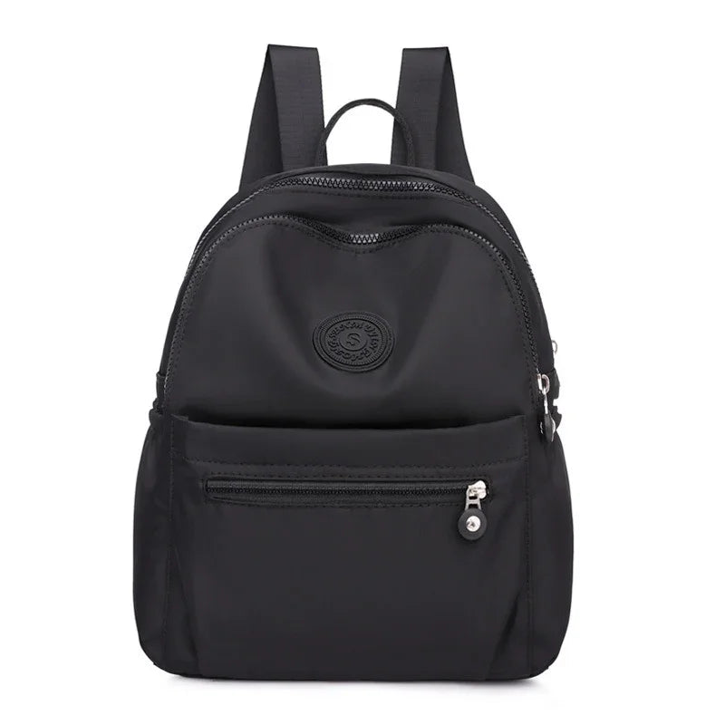Black nylon backpack with front zip pocket and adjustable shoulder straps