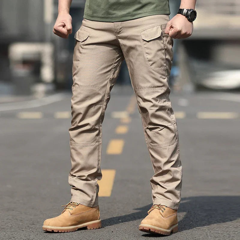 Men's beige tactical cargo pants paired with tan work boots on urban street