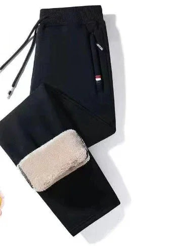 Black jogger pants with zippered pocket and beige fleece lining detail on white background