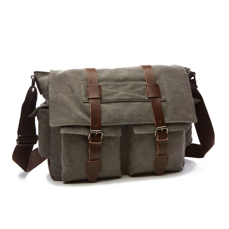 Gray canvas messenger bag with brown leather straps and front pockets on white background