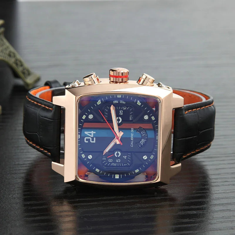 Square rose gold chronograph watch with black leather strap and blue dial on dark surface