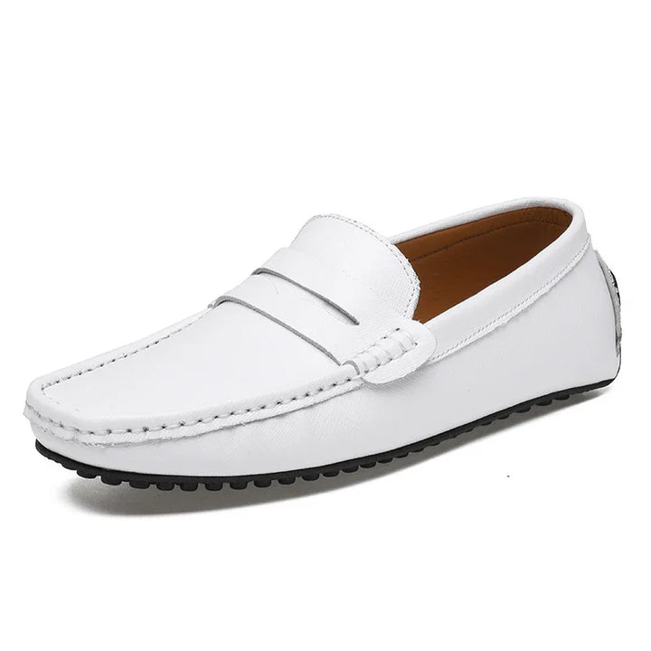 White men's leather driving loafer with black rubber sole and penny strap detail