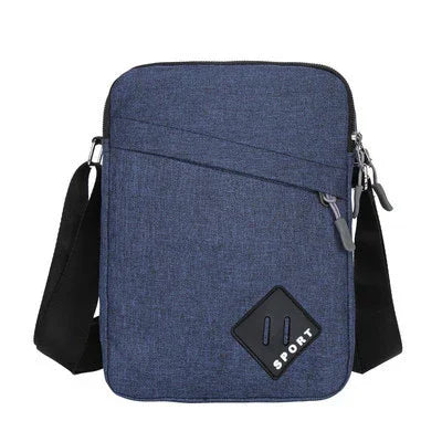 Compact blue fabric crossbody sport bag with zippered front pocket and adjustable black strap