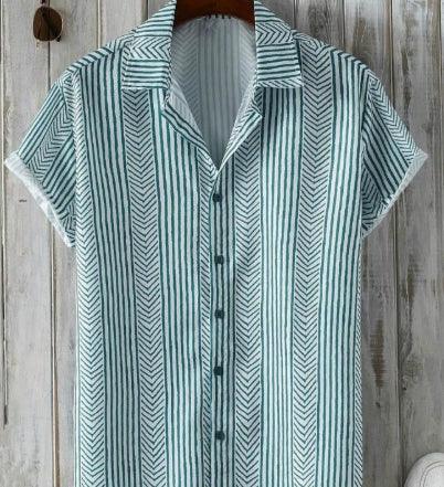 Short-sleeve green and white striped button-up shirt hanging on wooden wall
