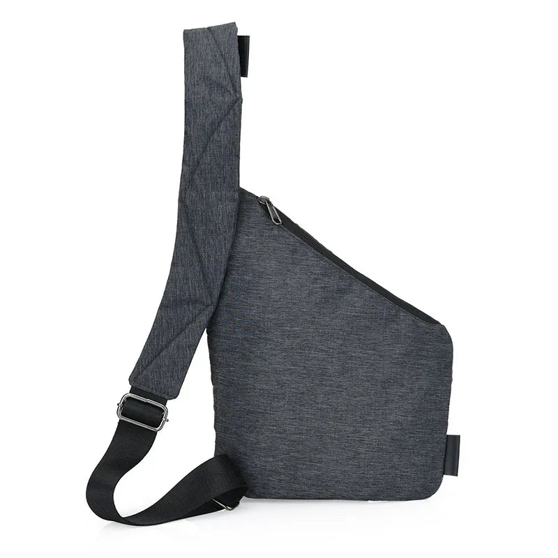 Grey crossbody sling bag with adjustable black strap and zipper closure on white background