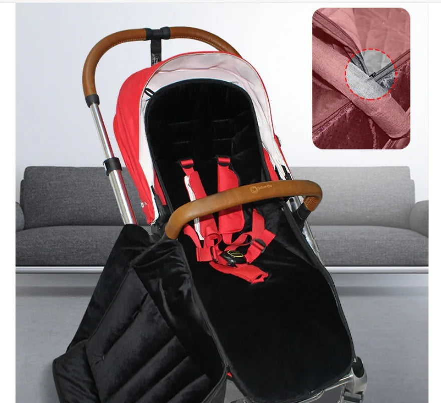 Modern baby stroller with red and black design, brown leather handle, and secure red harness