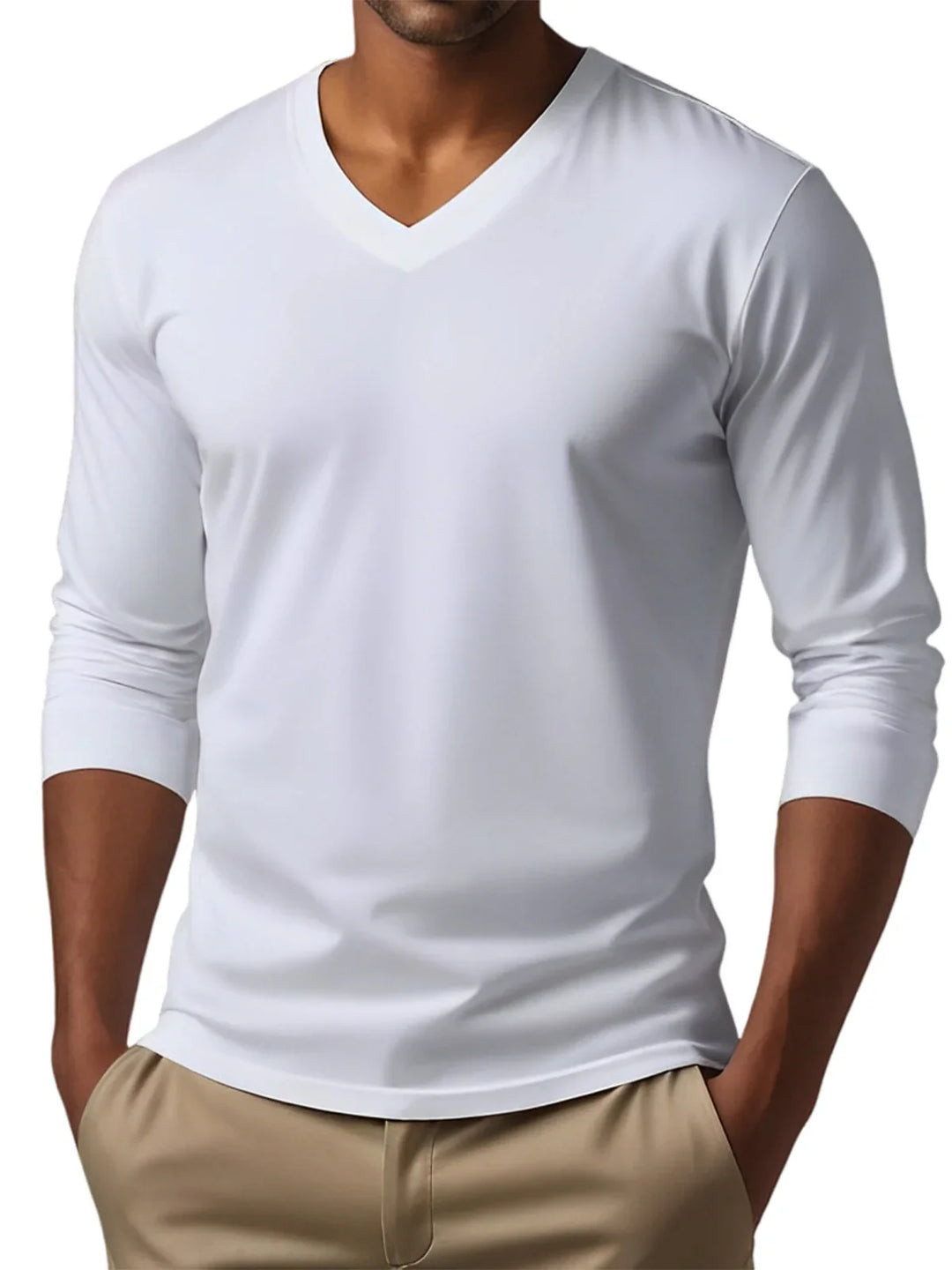 Man wearing white long sleeve V-neck T-shirt with khaki pants, hands in pockets