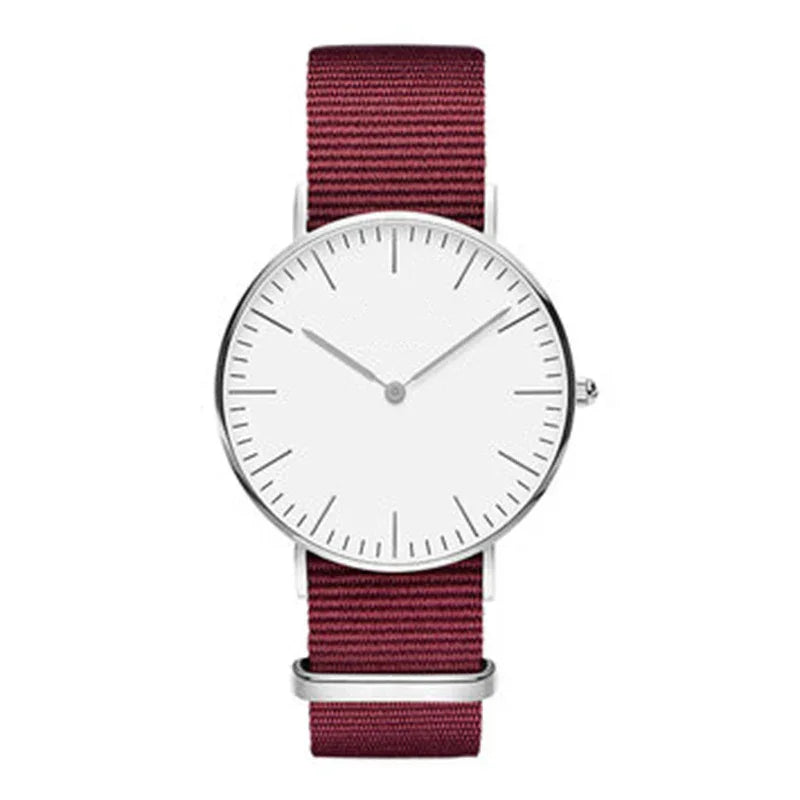 Minimalist wristwatch with white dial and silver case, featuring maroon fabric strap