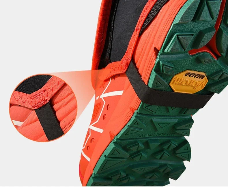 Close-up of orange and green trail running shoe with Vibram Megagrip sole and black strap detailing