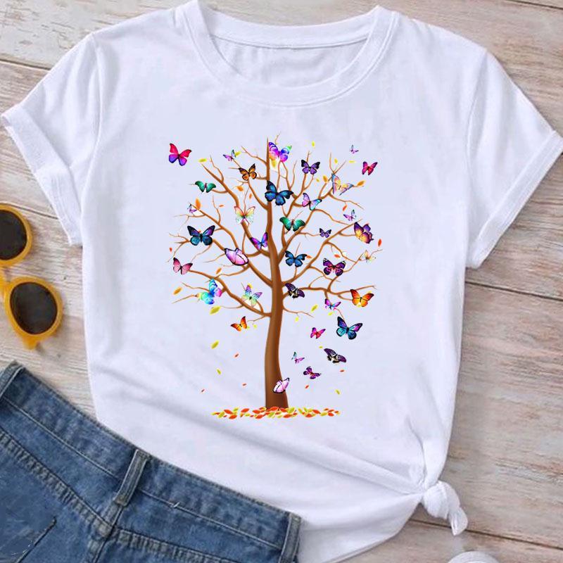 White T-shirt with colorful butterfly tree print, paired with denim shorts and sunglasses on wooden floor