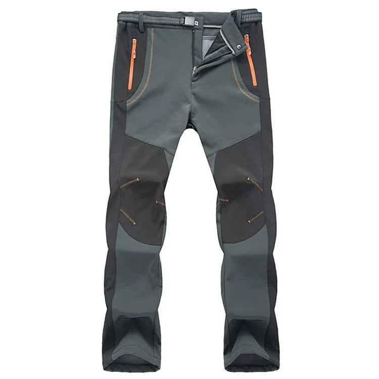 Men's outdoor hiking pants in gray and black with orange zippered pockets and reinforced knee patches