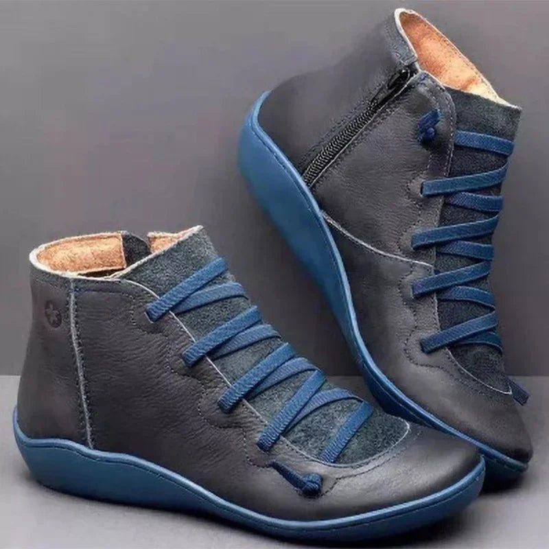 Dark gray ankle boots with blue laces, textured leather finish, and blue rubber soles