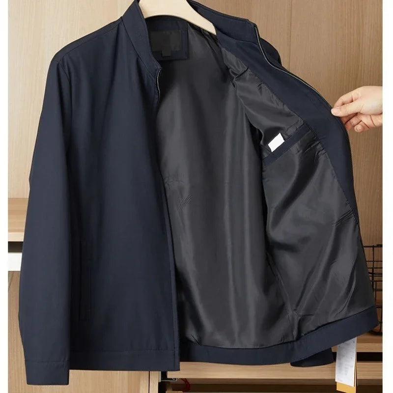 Navy blue lightweight men's jacket open to show smooth black inner lining with pocket, casual style