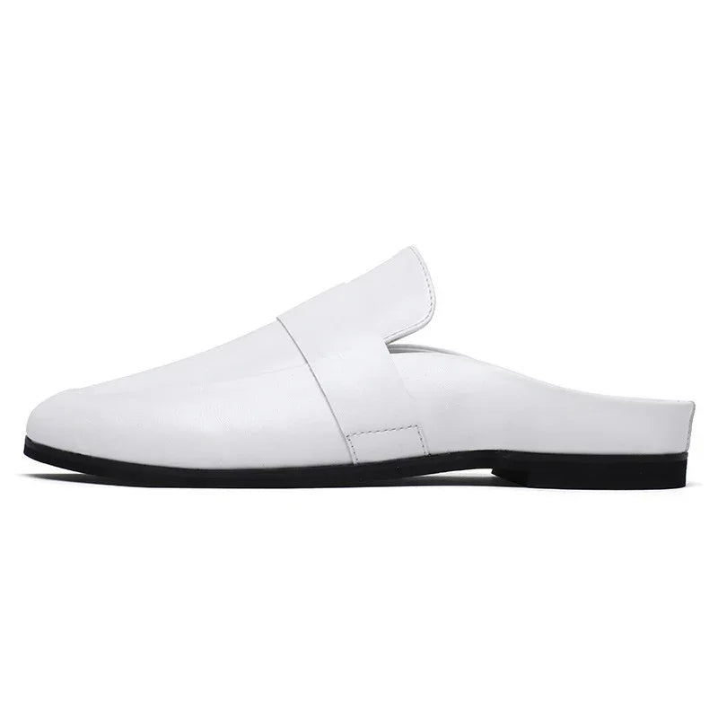 Minimalist white leather mule shoe with black sole on white background