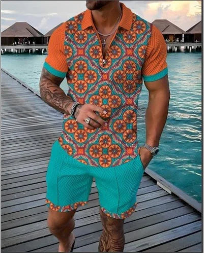 Man wearing vibrant orange and turquoise patterned summer shirt and shorts on wooden boardwalk over water