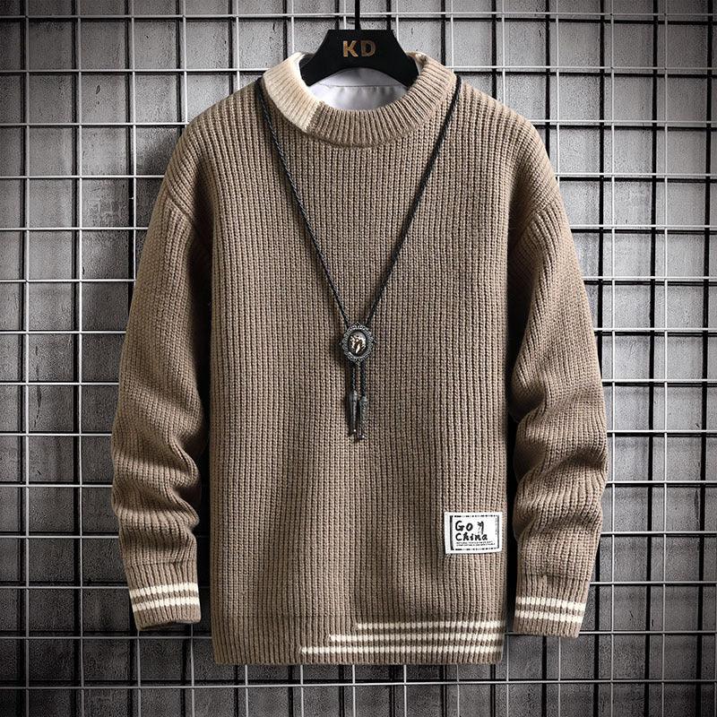 Brown ribbed knit sweater with beige collar and stripes, hanging on black hanger against metal grid background